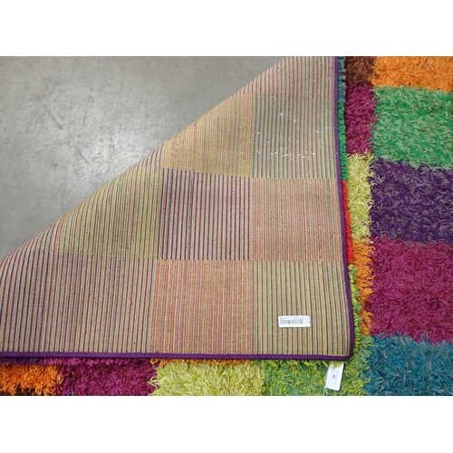 42 - A modern multi coloured square design shag pile Rug, 7ft10