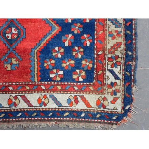 43 - A Kazak style Rug on blue ground with multi borders and large central motif and geometric designs, 5... 