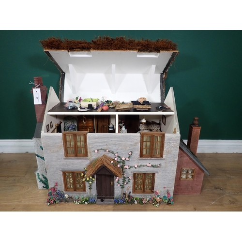 47 - A Thatched Cottage Dolls House with furniture, Garden, Veg Patch and Shed and wood store, 2ft 9