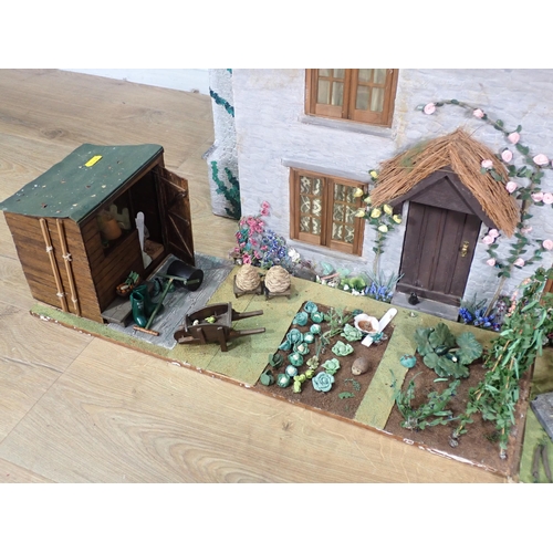 47 - A Thatched Cottage Dolls House with furniture, Garden, Veg Patch and Shed and wood store, 2ft 9