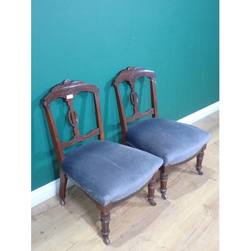 48 - A pair of Victorian Bedroom Chairs, with carved top rails, blue upholstered seats on turned front su... 