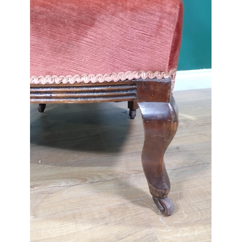 51 - A Victorian mahogany framed red upholstered Nursing Chair, and a pink upholstered Elbow Chair.