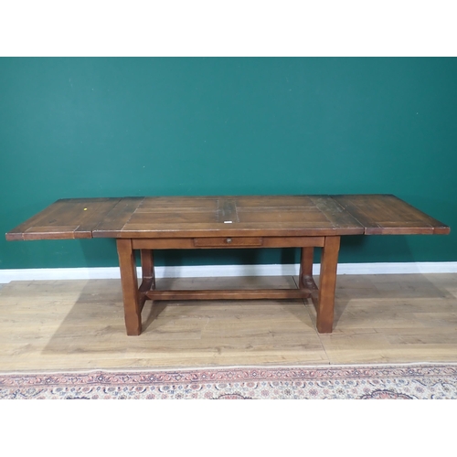 55 - An oak Refectory Table with single fitted drawer and two extension leaves, 5ft 4