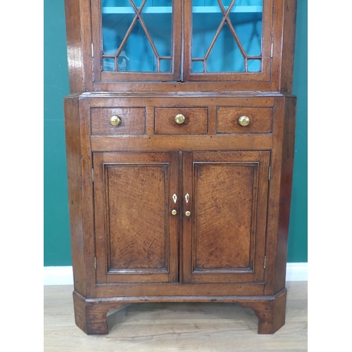 63 - A George III oak standing Corner Cabinet with glazed upper section above base fitted three drawers a... 