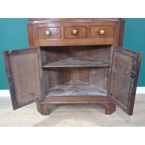 63 - A George III oak standing Corner Cabinet with glazed upper section above base fitted three drawers a... 