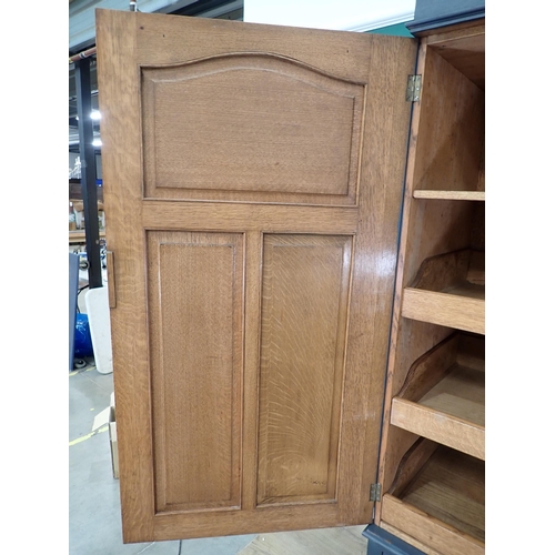 72 - A painted Oak Linen Press, the top with pair of panelled doors enclosing three slides, above a base ... 