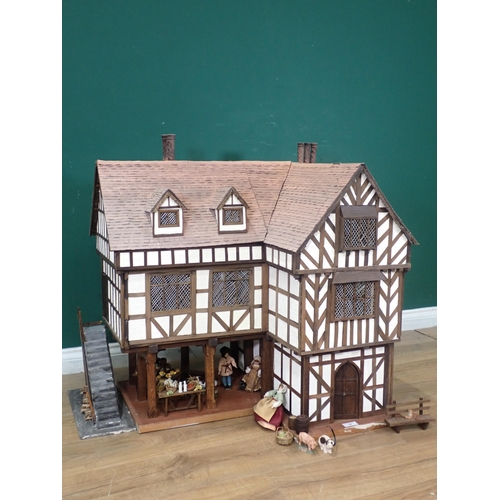 76 - A large Tudor style Dolls House, with some Furniture and three Figures, 3ft 2