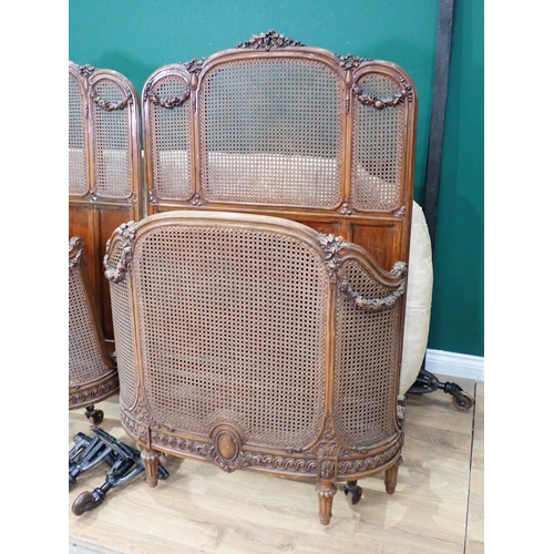 8 - A pair of Vono French single Beds with ribbon carved walnut frames and cane infill, one with mattres... 