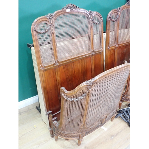 8 - A pair of Vono French single Beds with ribbon carved walnut frames and cane infill, one with mattres... 