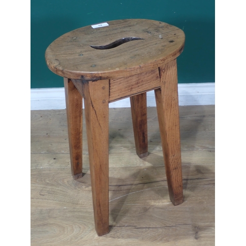 83 - An antique Dairy Stool with oval elm top mounted on oak square cut supports 1ft 9in H x 1ft 3in W