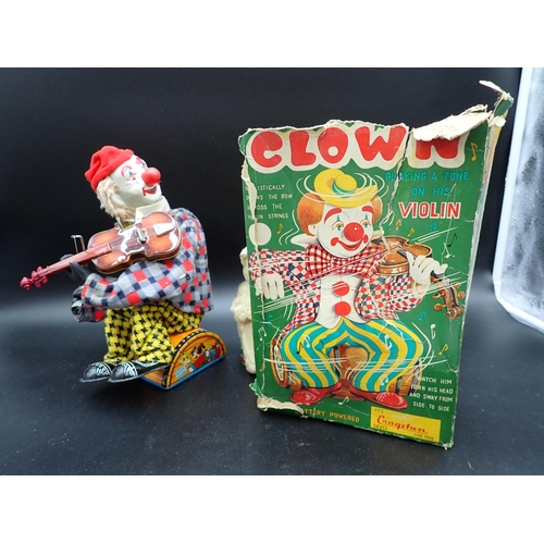 91 - A Japanese tinplate Clown playing a tune on his violin, with original box, and two clockwork Bears, ... 