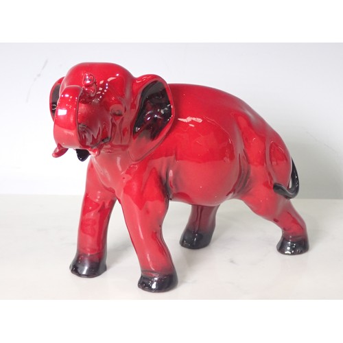 291 - A Royal Doulton Flambe Elephant with head and trunk raised 8in L x 5 1/4in H