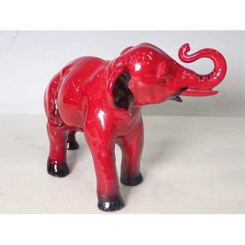 291 - A Royal Doulton Flambe Elephant with head and trunk raised 8in L x 5 1/4in H