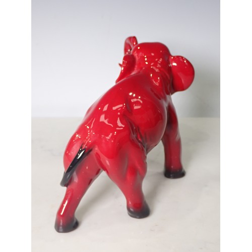 291 - A Royal Doulton Flambe Elephant with head and trunk raised 8in L x 5 1/4in H