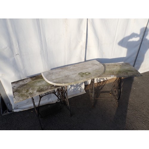 727 - A cast iron singer sewing base with marble top with another cast iron base with marble top and a spa... 