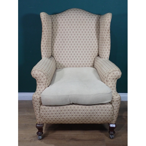 16 - An antique winged Armchair on cabriole front supports and casters 3ft 8in H x 2ft 8in W