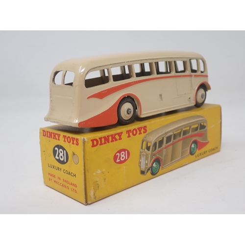 1312 - A boxed Dinky Toys No.281 Luxury Coach in cream with red flash and hubs