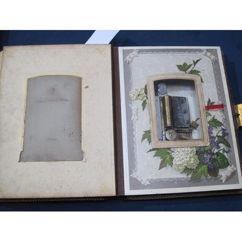 407 - A late 19th Century family Photo Album incorporating a Music Box, the album bound in padded leather ... 