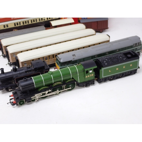 1650 - An unboxed Hornby 00 gauge 'Flying Scotsman', three LNER teak Coaches, Triang Diesel Locomotive, 0-6... 