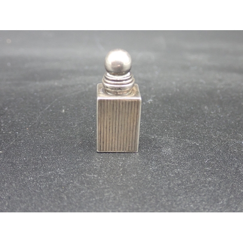 128 - A small sterling silver square Scent Bottle and Stopper with ribbed design, marked Tiffany & Co, 1¼i... 