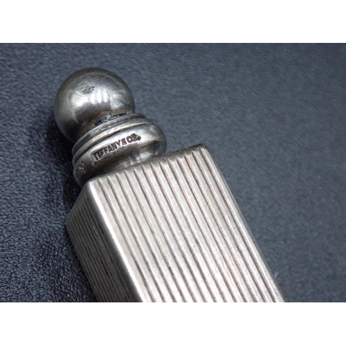 128 - A small sterling silver square Scent Bottle and Stopper with ribbed design, marked Tiffany & Co, 1¼i... 