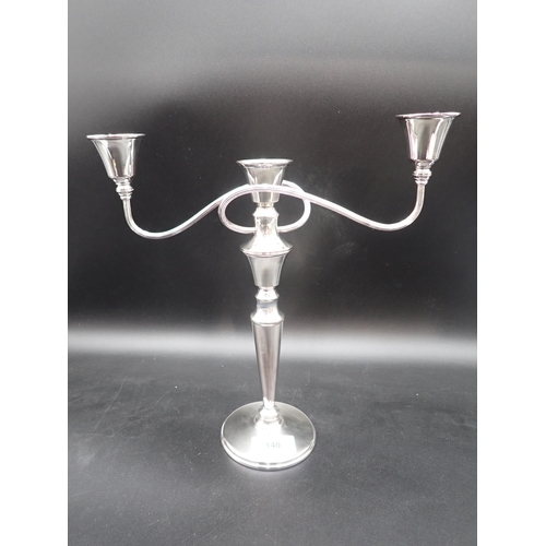 140 - A 1970's plated two branch, three light Candlestick on circular base