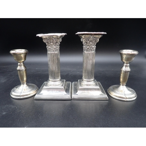 143 - A pair of Victorian silver Candlesticks with fluted columns, having corinthian capitals on beaded sq... 