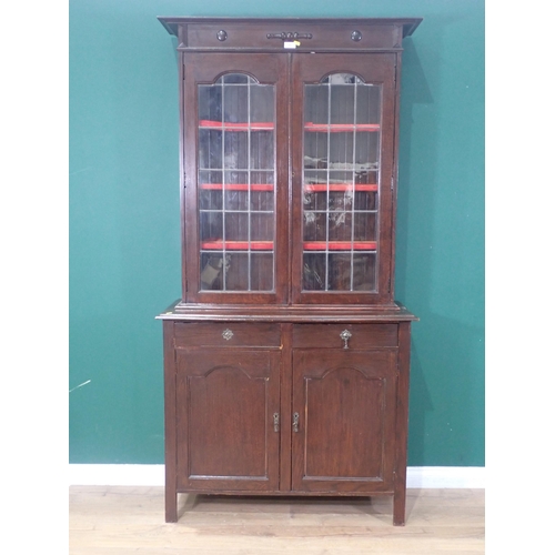 15 - A mahogany leaded glass front Bookcase fitted with three shelves, above two cupboard doors on raised... 