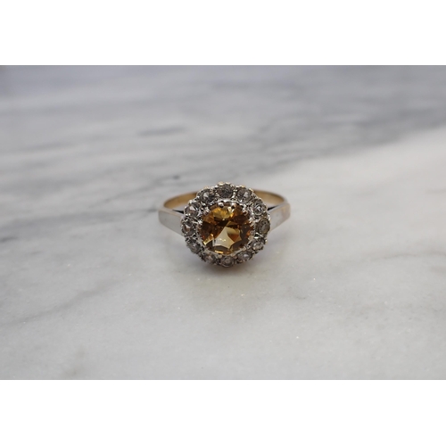 163 - A Citrine Cluster Ring claw-set round citrine within a frame of twelve white stones, in 9ct gold, ri... 