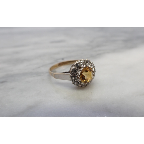 163 - A Citrine Cluster Ring claw-set round citrine within a frame of twelve white stones, in 9ct gold, ri... 