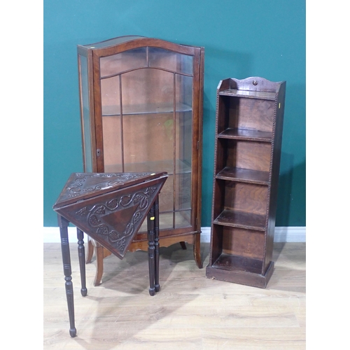 17 - A walnut veneered display cabinet fitted two glass shelves a carved wood side table and a small maho... 