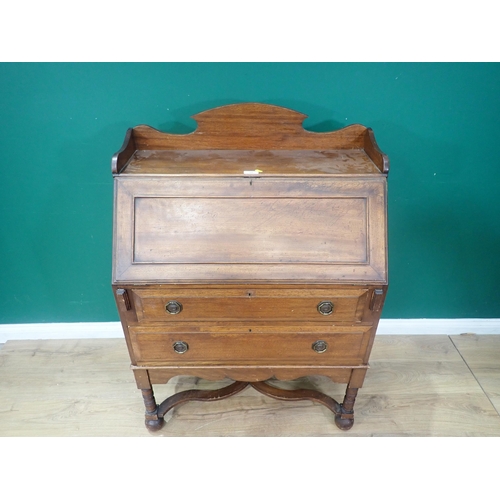 19 - A mahogany Bureau on Stand, the fall down enclosing four fitted drawers and pigeon holes, on turned ... 