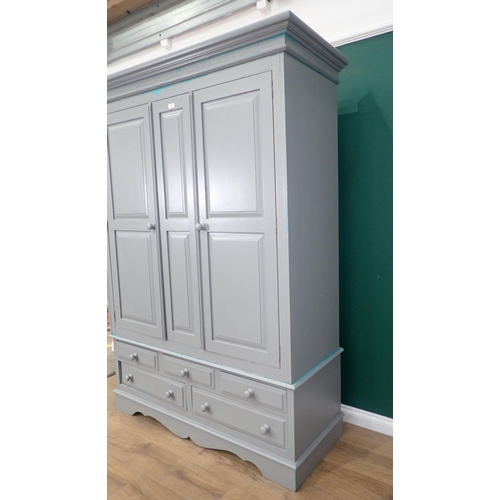 20 - A modern painted pine Wardrobe, the top section with pair of panelled doors, above the base fitted t... 