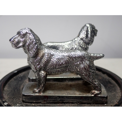 297 - A pair of chrome plated Spaniel Car Mascots, 3in L x 2 1/4in H, mounted on a wooden stand