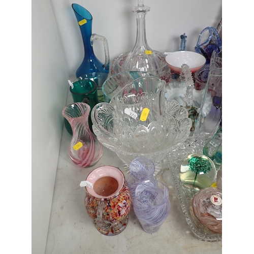 320 - A large quantity of coloured and clear glass including a decanter, vases, bowls, etc