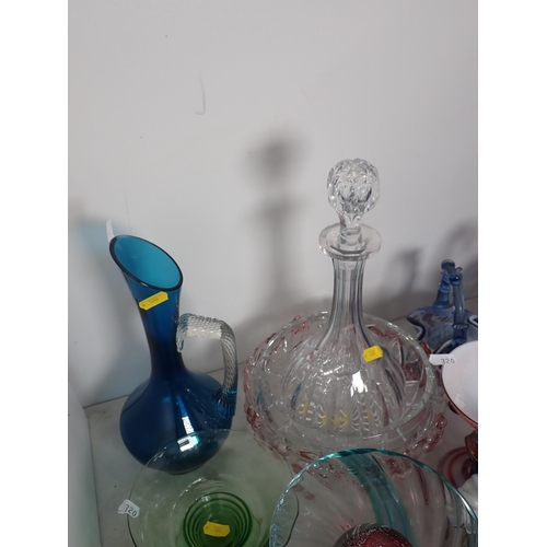 320 - A large quantity of coloured and clear glass including a decanter, vases, bowls, etc