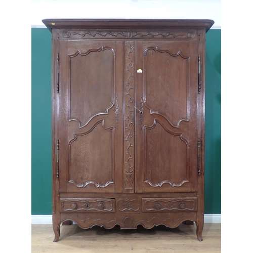 49 - A French oak Armoire, the moulded cornice above pair of carved panelled doors, enclosing a shelved i... 