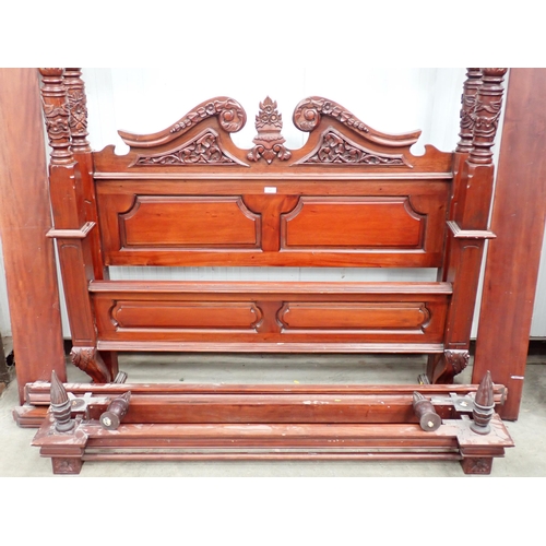 525 - A reproduction mahogany Four Poster Bed with carved headboard, carved and turned posts and finials, ... 