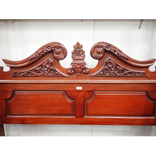 525 - A reproduction mahogany Four Poster Bed with carved headboard, carved and turned posts and finials, ... 