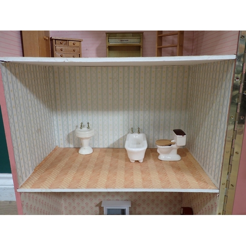 529 - A pink painted Dolls House with some Furniture, 29