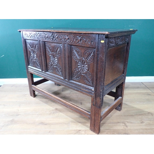 533 - An antique oak Coffer with carved three panel front, raised on later stand and stretchers, 3ft 1