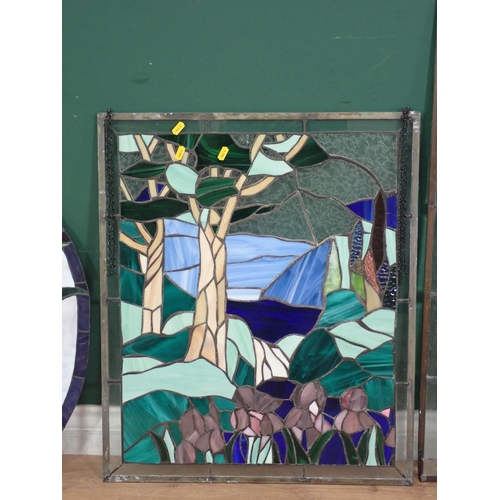 580 - An oval framed stain glass Panel, a rectangular coloured glass Panel, and another with green leafage... 