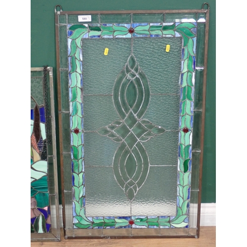 580 - An oval framed stain glass Panel, a rectangular coloured glass Panel, and another with green leafage... 