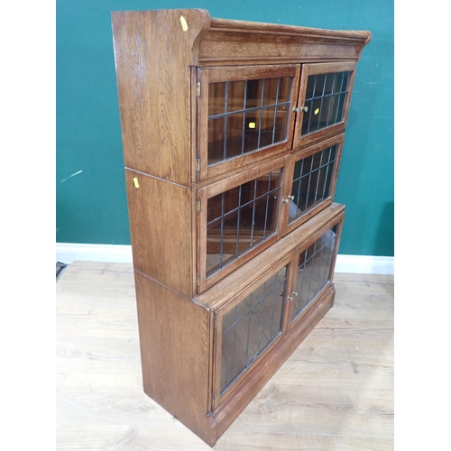 597 - A pair of oak Bookcases with leaded glass panels in three graduated sections and plinth bases, 3ft 9... 