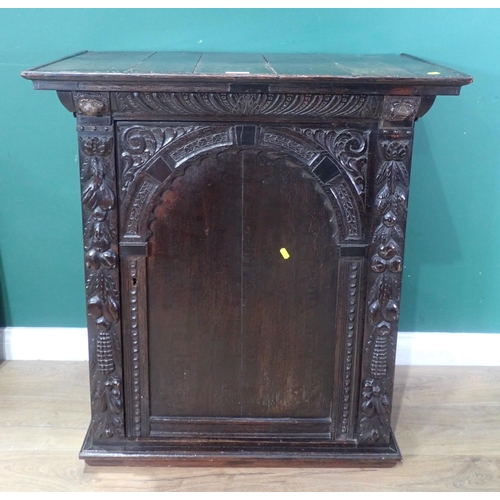 605 - An antique oak Cupboard with single arched carved door, 3ft 1in H x 2ft 10in W