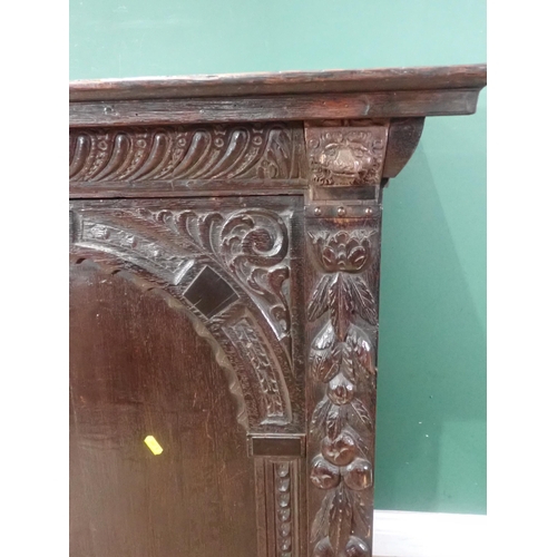 605 - An antique oak Cupboard with single arched carved door, 3ft 1in H x 2ft 10in W