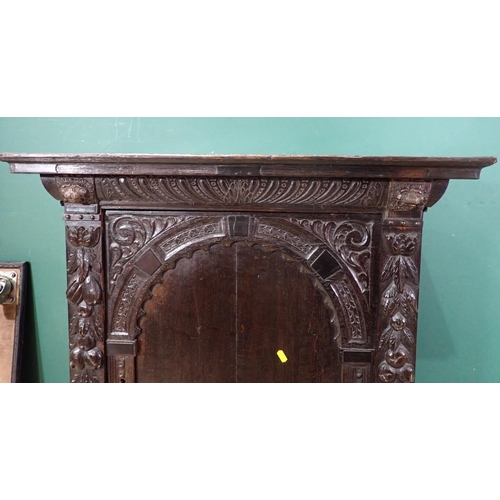 605 - An antique oak Cupboard with single arched carved door, 3ft 1in H x 2ft 10in W