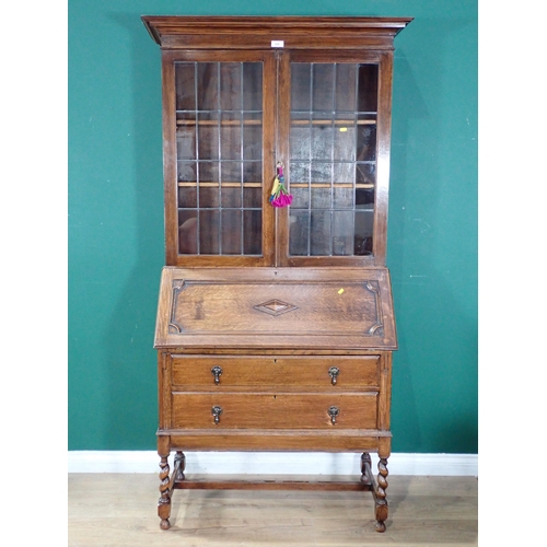 606 - An oak glazed top Bureau Bookcase, the fall front enclosing pigeon hole interior above two long draw... 