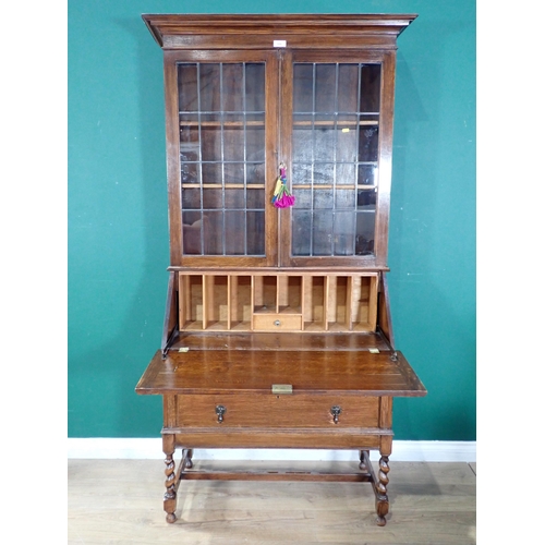 606 - An oak glazed top Bureau Bookcase, the fall front enclosing pigeon hole interior above two long draw... 