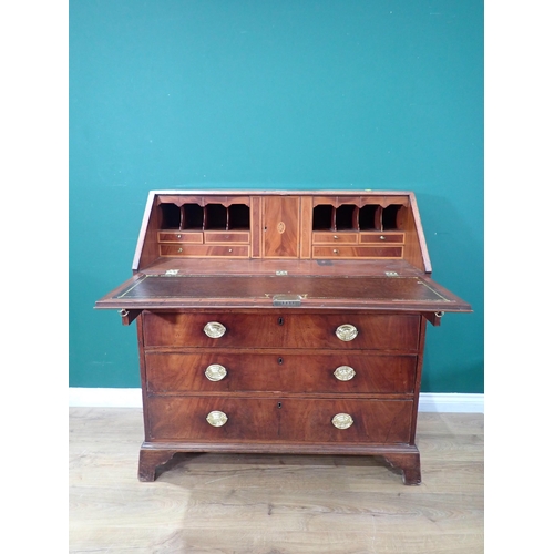 634 - A 19th Century mahogany and crossbanded Bureau, the fall down enclosing drawer and pigeon hole inter... 